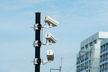 closed-circuit camera on white clouds background, blurred structure background,