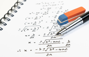 Handwriting of mathematics quadratic equation formula on examination, practice, quiz or test in...