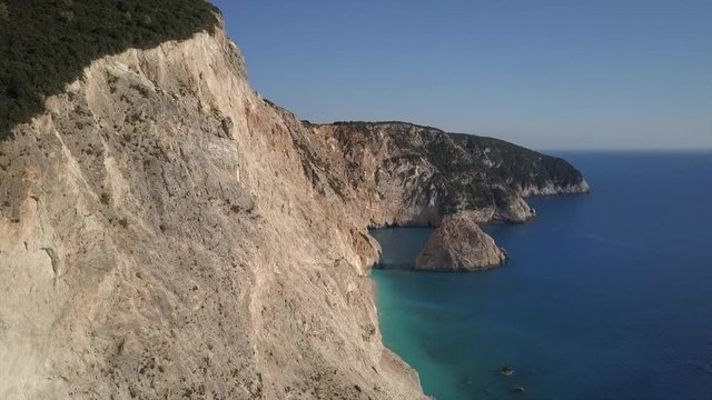 Amazing beach and steep cliffs in an aerial view turquoise and blue water