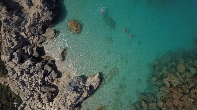 Swimmers in crystal clear turquoise, blue water. Mediterranean colors