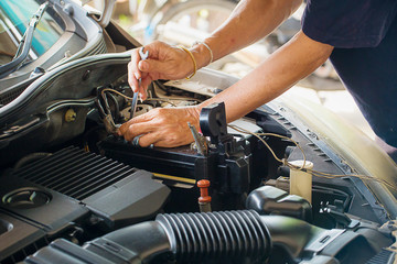 Fototapeta na wymiar Engine engineer is replacing car battery because car battery is depleted. concept car maintenance 
