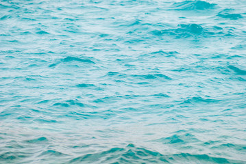 Photo closeup of beautiful clear turquoise sea ocean water surface with ripples low waves on seascape background. horizontal picture
