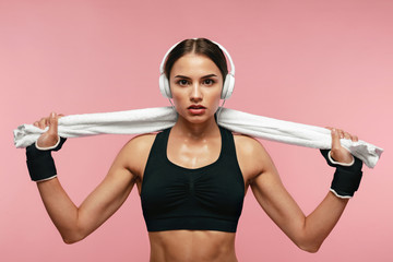 Sport Woman Listening Music In Headphones On Training