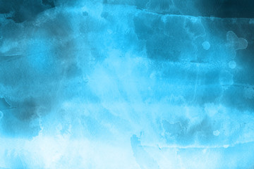 Blue winter watercolor ombre leaks and splashes texture on white watercolor paper background. Painted ice, frost and water.