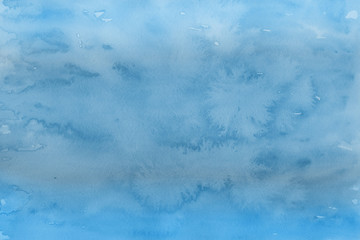 Blue winter watercolor ombre leaks and splashes texture on white watercolor paper background. Painted ice, frost and water.