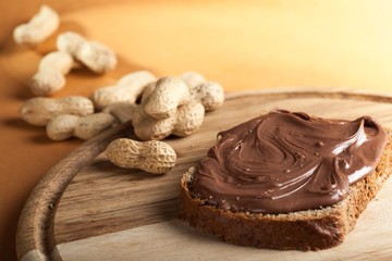 Peanutbutter Sandwich on Cutting Board with Peanuts in