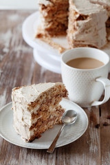 ePiece of crispy coffee and nut meringue cake with butter cream frosting
