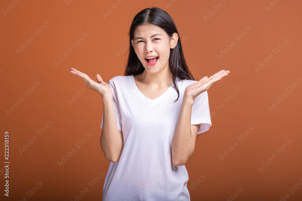 Wall mural Surprise woman over orange background.