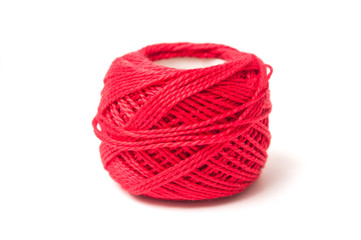 closeup of wooden bobbins of red cotton yarn