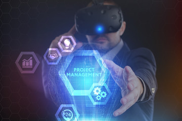 The concept of business, technology, the Internet and the network. A young entrepreneur working on a virtual screen of the future and sees the inscription: Project management