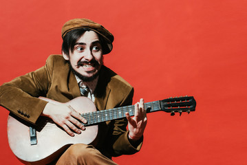 positive guy playing guitar in the Studio