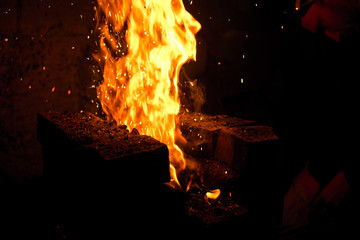 Fototapeta premium Fire of a charcoal forge, in an old smithy