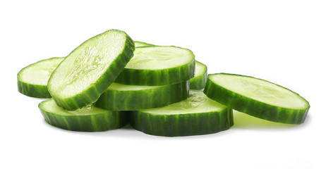 Fresh cucumber slices, isolated on white background. Close up shot of cucumber, arrangement or pile.