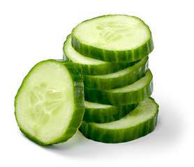 Fresh cucumber slices, isolated on white background. Close up shot of cucumber, arrangement or pile.