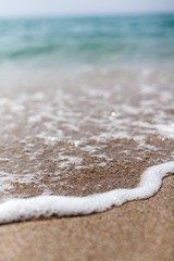 Fototapeta na wymiar Closeup of Wave of the Sea on a Beach