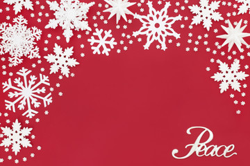 Christmas peace sign and white snowflake decorations on red background. Traditional Christmas greeting card for the holiday season.