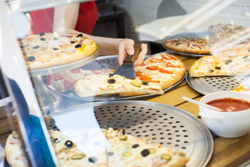 pizza in the window behind the glass