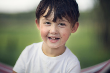 boy looking at the camera outdoors