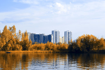 Krasnoyarsk city on the banks of the Yenisei river. Beautiful autumn in Siberia. Autumn landscape. Yellow foliage in the sun.
