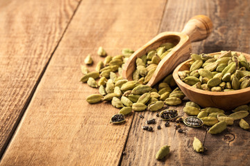 Green cardamom on wooden table