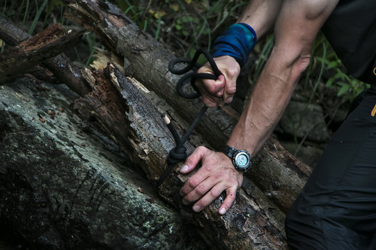 Closeup Of Man's Hand Tying A Knot