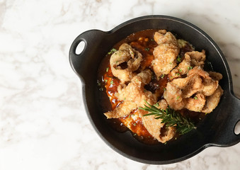 mashed potatoes with fried chicken skin topping, isolated on the marble table, soft focus