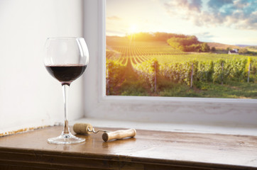 red wine bottle and wine glass on wodden barrel