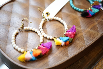 Colorful earrings with empty tags for your text on display