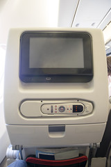 Movie screen on passenger seat of commercial airplane with space for your text.   