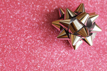 Gift concept, silver ribbon, glitter pink background