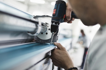 Manual worker assembling PVC doors and windows. Manufacturing jobs. Selective focus. Factory for aluminum and PVC windows and doors production.