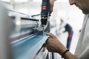 Manual worker assembling PVC doors and windows. Manufacturing jobs. Selective focus. Factory for aluminum and PVC windows and doors production.