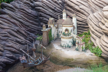 Model Castle with a pirate ship. miniature model of fairy tales castle and pirate adventure, bed time story telling concept, fantasy world.