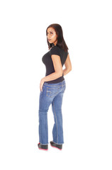 Tall woman standing in jeans from the back