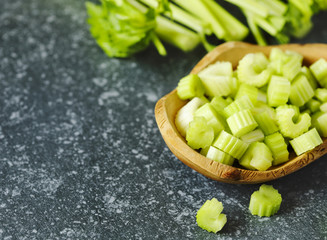 Fresh celery in wooden bowl