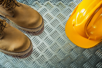 Safety boots hard hat on fluted metal sheet