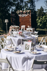 a wedding table with cutlery, candles and flowers.