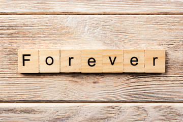 forever word written on wood block. forever text on table, concept