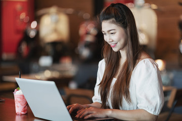 Beautiful Attractive Business Asian woman working with laptop and looking in monitor smile and have positive emotional feeling so happiness,Business Startup Concept