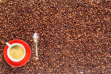 a cup of coffee on a background of coffee beans