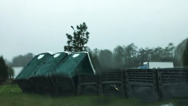 Winds and rain from a hurricane blow through a highway rest area on an evacuation route in the Southern USA