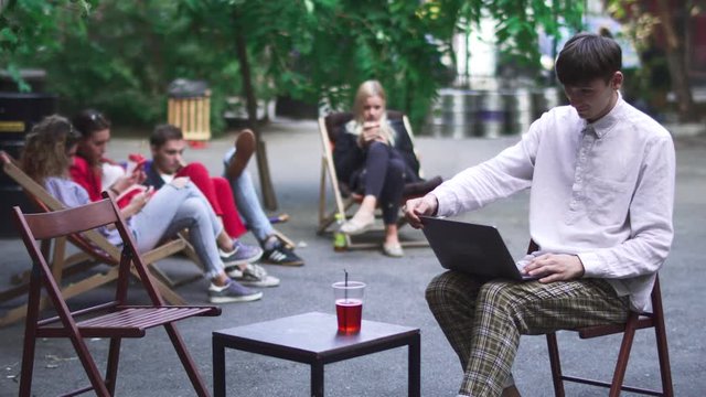 Young man finish his work at netbook and goes away