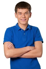 Teenage male standing with his arms folded in front of him