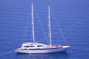 Fototapeta na wymiar Yacht anchored to shore in Greece, Santorini Island