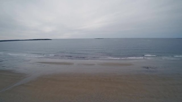 View of beach and empty sandy beaches of ocean during low tide