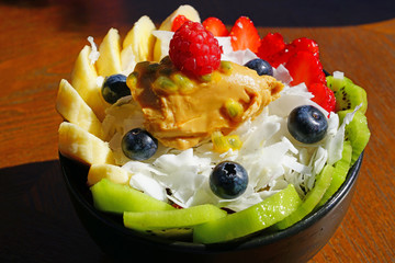 View of a frozen acai bowl with fresh fruit and peanut butter