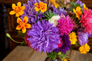 Colorful autumn flowers. Bouquet of asters and marigolds. Selective focus