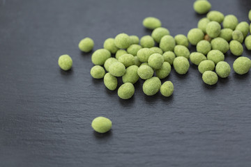 Snack, peanuts in the coating of wasabi. Close up