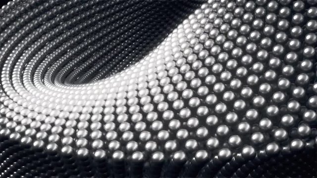 A close up view of an animated abstract background, created from waves of metallic spheres.