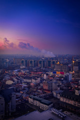 Morning view above the city with city lights and traffic lights and illuminated buildings from Bararab overpass with steam coming out from the horn